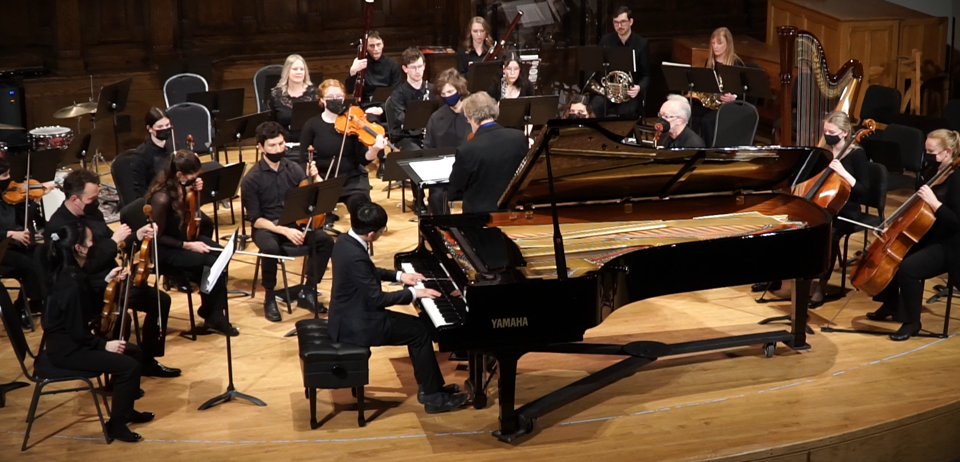 Eu-Rway Chew performing a piano concerto with a full chamber orchestra